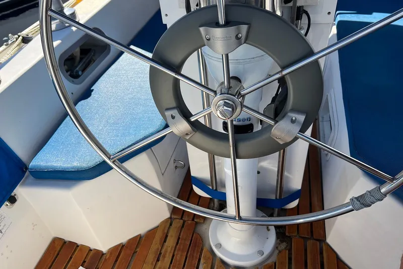 Slide: The Image of Steering wheel of a 1988 Catalina 34 mkI sailboat with blue seating and wooden deck. - 9