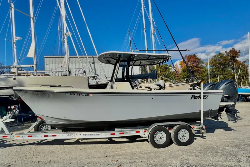 Slide: The Image of 2025 Parker 2600 Center Console boat on trailer, labeled "Incoming Trade." - 0