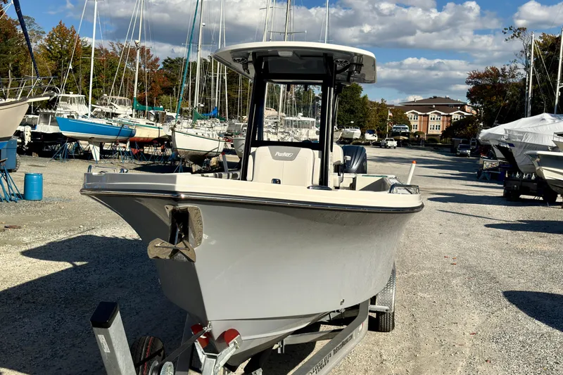 Slide: The Image of 2025 Parker 2600 Center Console boat on trailer in marina under blue sky. - 1