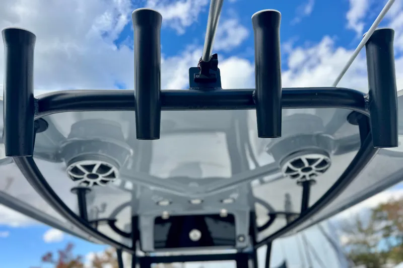 Slide: The Image of 2025 Parker 2600 Center Console boat, rod holders and speakers, under a blue sky. - 14