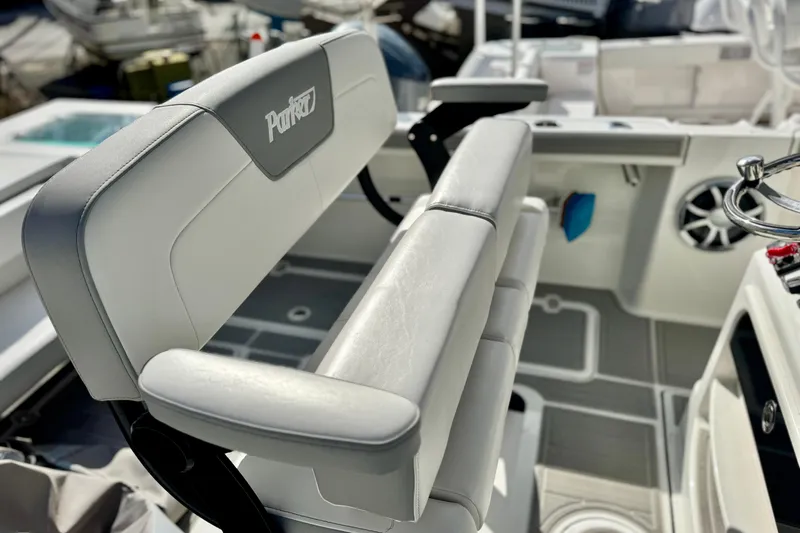 Slide: The Image of 2025 Parker 2600 Center Console boat interior with cushioned seating and steering wheel. - 17
