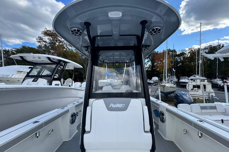 Slide: The Image of 2025 Parker 2600 Center Console boat at marina, showcasing sleek design and modern features. - 2