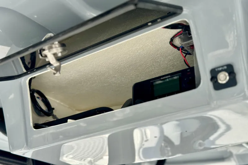 Slide: The Image of Open compartment of 2025 Parker 2600 Center Console boat showing wiring and electronics. - 22
