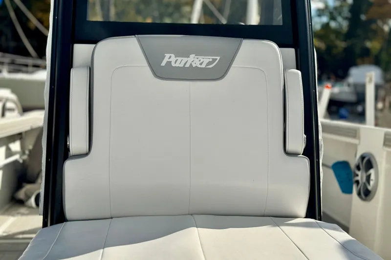 Slide: The Image of 2025 Parker 2600 Center Console boat seat with logo, featuring sleek white upholstery. - 27