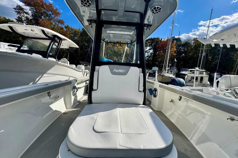 Slide: The Image of 2025 Parker 2600 Center Console boat with sleek seating and modern design in a marina setting. - 28