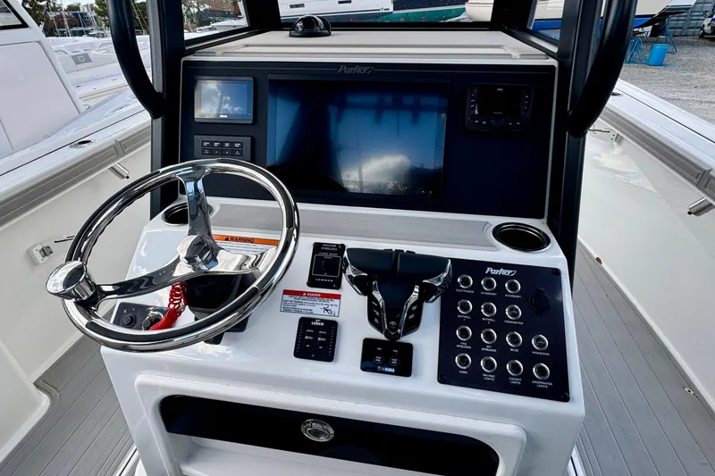Slide: The Image of 2025 Parker 2600 Center Console boat dashboard with steering wheel and control panel. - 3