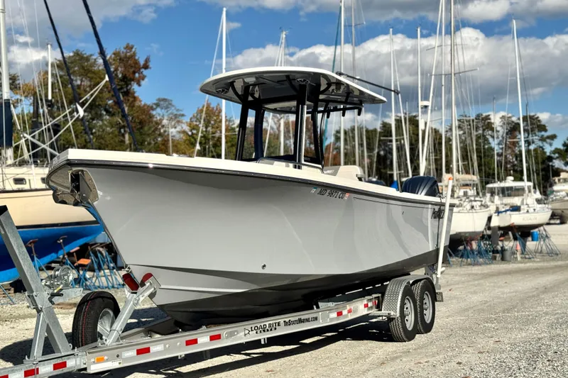 Slide: The Image of 2025 Parker 2600 Center Console boat on trailer in marina setting. - 36