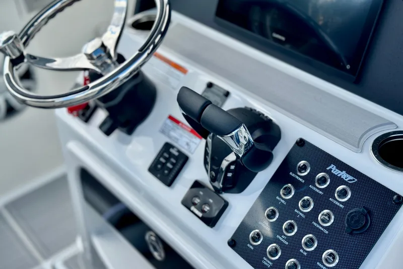 Slide: The Image of 2025 Parker 2600 Center Console boat dashboard with steering wheel and control panel. - 4
