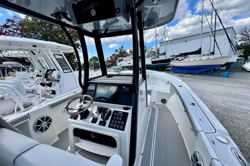 Slide: The Image of 2025 Parker 2600 Center Console boat interior with modern controls and steering wheel. - 6