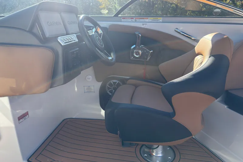 Slide: The Image of Interior of 2026 Crownline 298 SS boat with Garmin displays and luxury seating. - 10