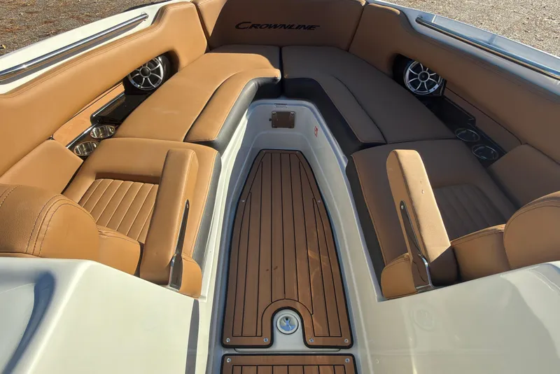 Slide: The Image of 2026 Crownline 298 SS boat interior with tan leather seating and wood flooring. - 11