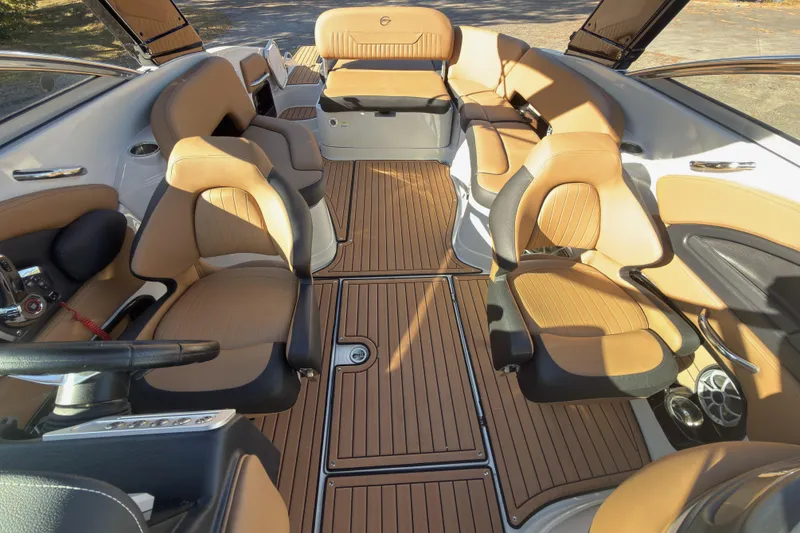 Slide: The Image of 2026 Crownline 298 SS boat interior with tan leather seating and wood flooring. - 14