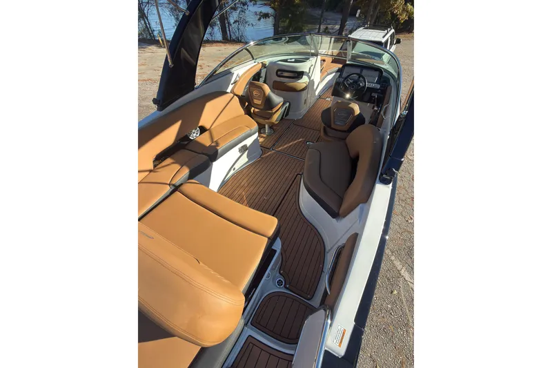 Slide: The Image of 2026 Crownline 298 SS boat interior with tan leather seating and sleek design. - 15