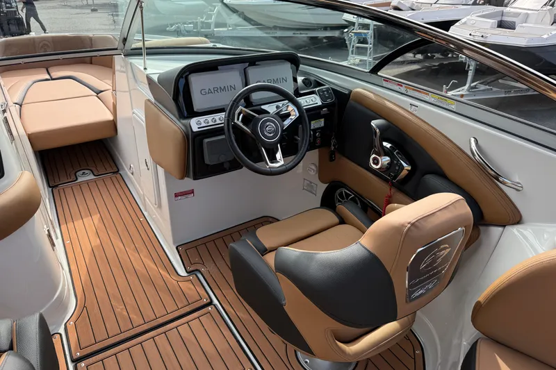 Slide: The Image of 2026 Crownline 298 SS boat interior with tan leather seats and wood-style flooring. - 5