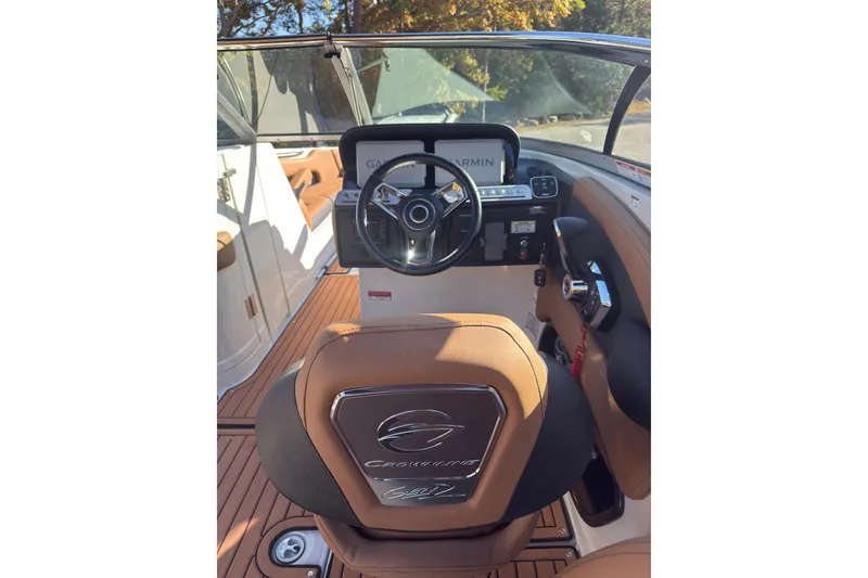 Slide: The Image of 2026 Crownline 298 SS boat interior with steering wheel and dashboard. - 8