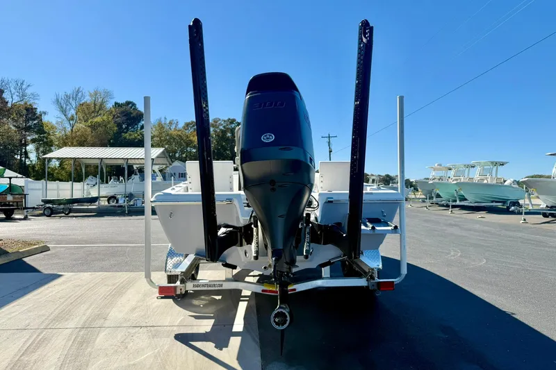 Slide: The Image of 2026 Key West 230 Bay Reef boat on trailer, rear view, in a marina setting. - 1