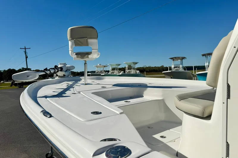 Slide: The Image of 2026 Key West 230 Bay Reef boat with seating and fishing deck under clear blue sky. - 12