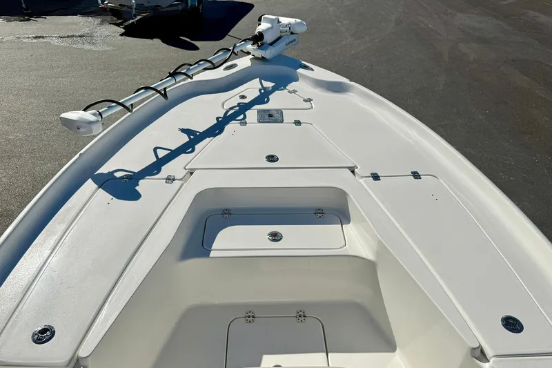 Slide: The Image of 2026 Key West 230 Bay Reef boat deck with storage compartments and trolling motor. - 14
