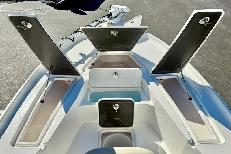 Slide: The Image of 2026 Key West 230 Bay Reef boat with open storage compartments on deck. - 15