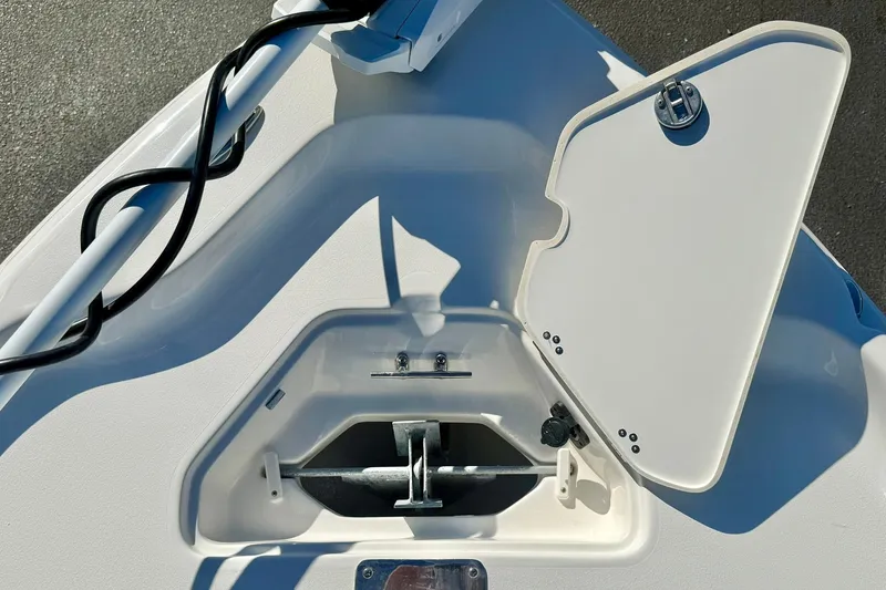 Slide: The Image of 2026 Key West 230 Bay Reef boat anchor compartment with open hatch. - 16