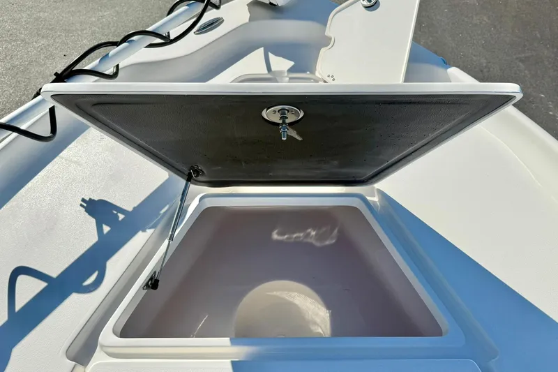 Slide: The Image of Open storage compartment on 2026 Key West 230 Bay Reef boat. - 18