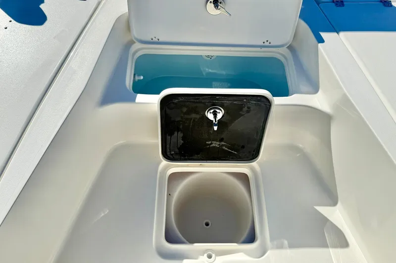 Slide: The Image of 2026 Key West 230 Bay Reef boat storage compartments with open lids. - 20