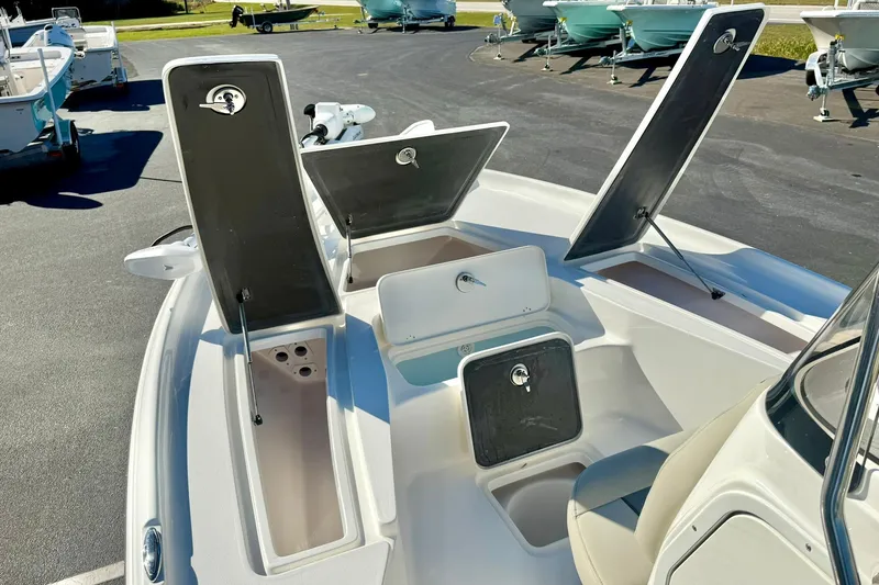 Slide: The Image of 2026 Key West 230 Bay Reef boat with open storage compartments on deck. - 22