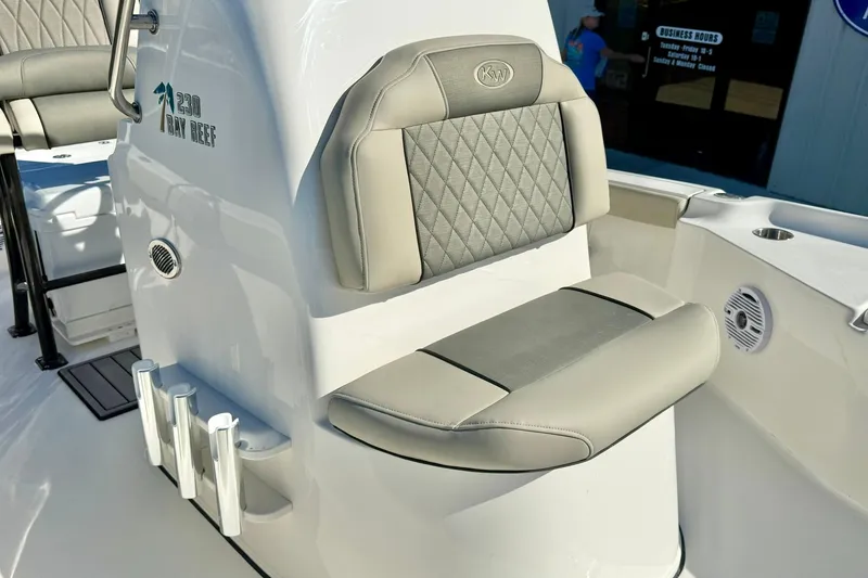 Slide: The Image of 2026 Key West 230 Bay Reef boat interior with cushioned seating and rod holders. - 25