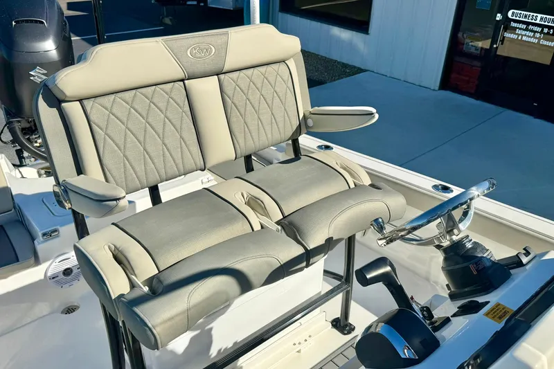 Slide: The Image of 2026 Key West 230 Bay Reef boat interior with cushioned seating and steering console. - 29