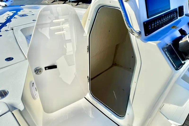 Slide: The Image of 2026 Key West 230 Bay Reef boat console with open storage compartment and control panel. - 32