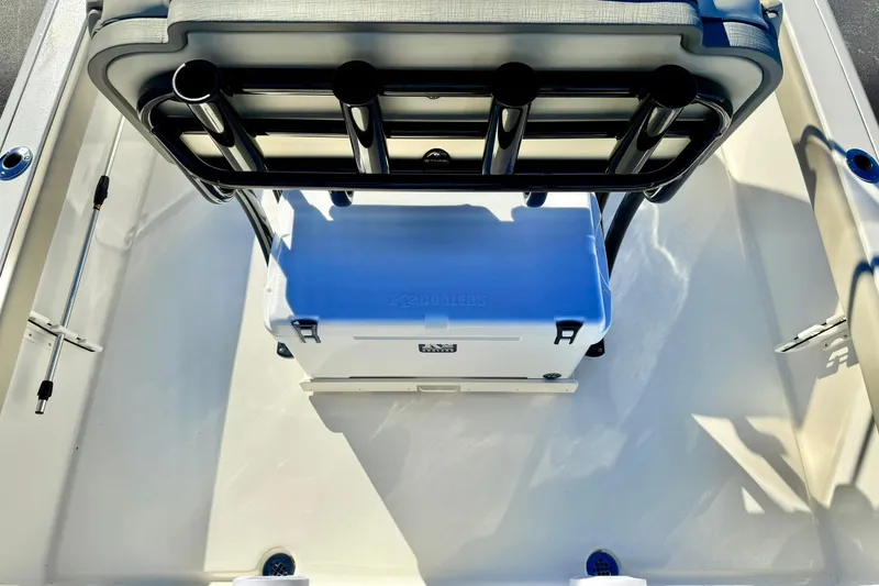 Slide: The Image of 2026 Key West 230 Bay Reef boat interior with cooler and rod holders. - 34