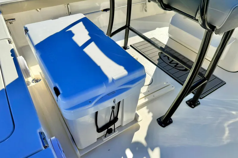 Slide: The Image of 2026 Key West 230 Bay Reef boat interior with cooler and seating area. - 35