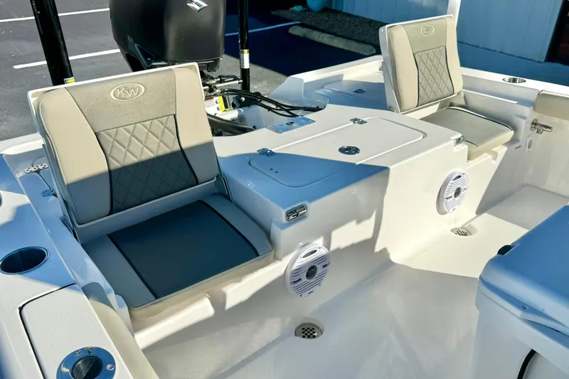 Slide: The Image of 2026 Key West 230 Bay Reef boat interior with cushioned seating and built-in speakers. - 40