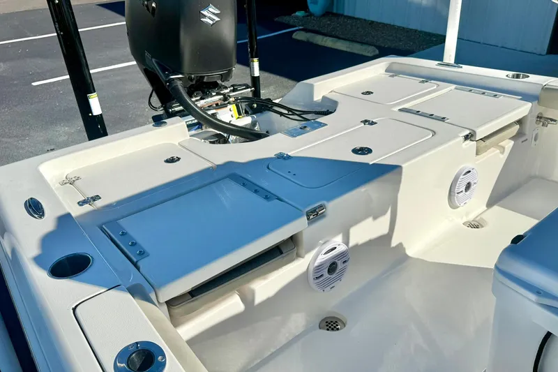 Slide: The Image of 2026 Key West 230 Bay Reef boat interior with storage compartments and motor. - 41