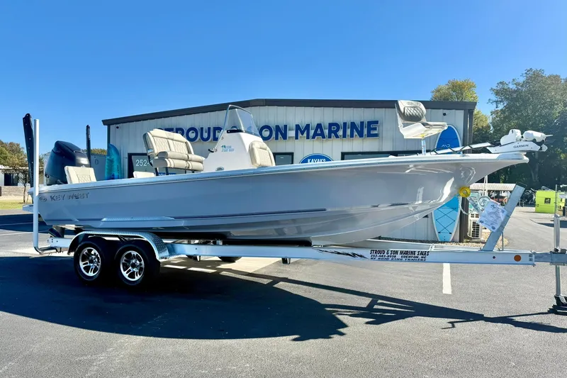 Slide: The Image of 2026 Key West 230 Bay Reef boat on trailer, displayed at marine dealership. - 5