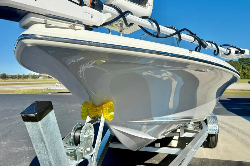 Slide: The Image of 2026 Key West 230 Bay Reef boat on trailer, close-up view of hull and bow. - 7