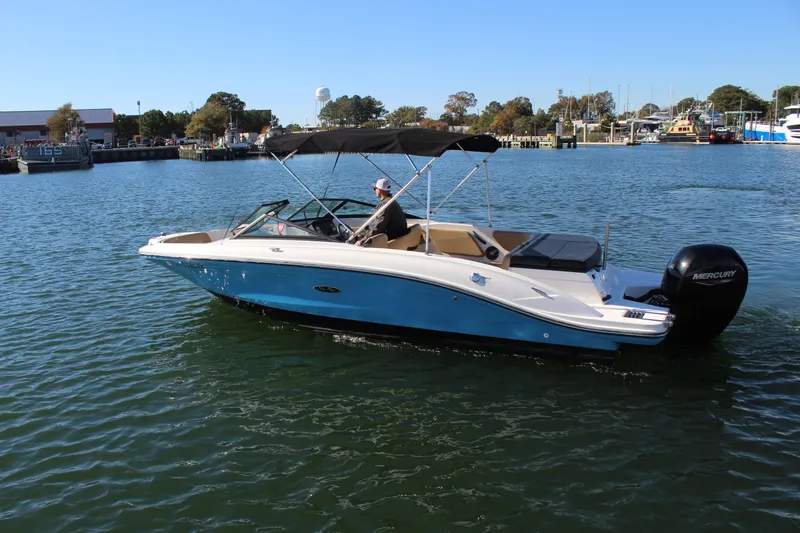 Slide: The Image of 2023 Sea Ray SPX 210 boat cruising on a sunny day in a marina. - 10