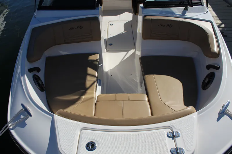 Slide: The Image of 2023 Sea Ray SPX 210 boat interior with tan seating and sleek design. - 11