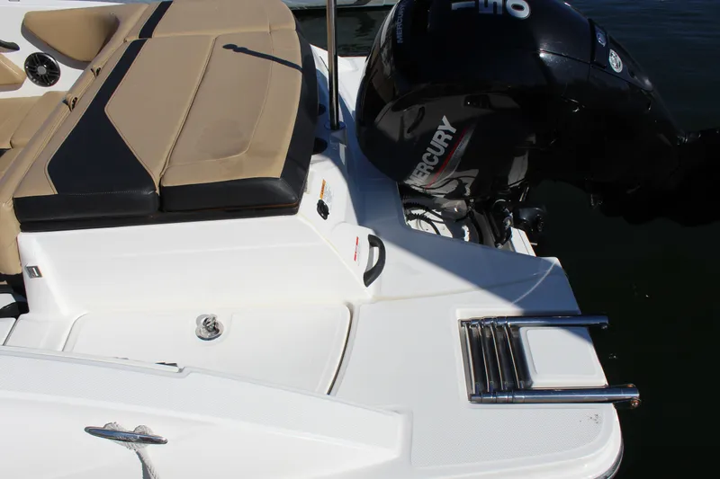 Slide: The Image of 2023 Sea Ray SPX 210 boat with Mercury engine and beige seating. - 13