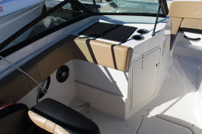 Slide: The Image of 2023 Sea Ray SPX 210 boat interior with seating and storage compartments. - 15