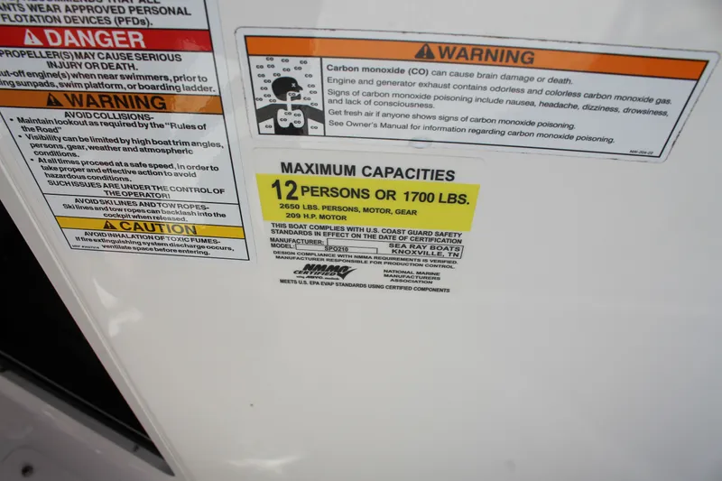 Slide: The Image of 2023 Sea Ray SPX 210 capacity label: 12 persons or 1700 lbs, safety warnings included. - 17