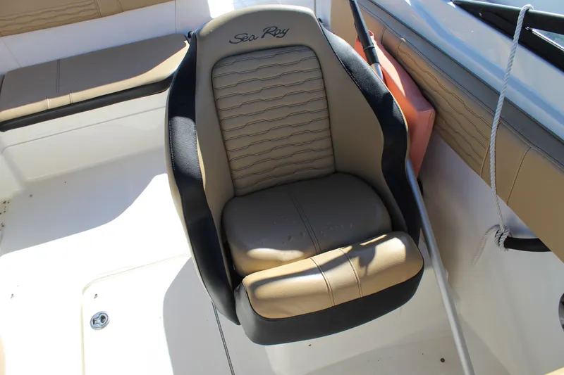 Slide: The Image of Captain's seat on 2023 Sea Ray SPX 210 boat, featuring tan and black upholstery. - 18