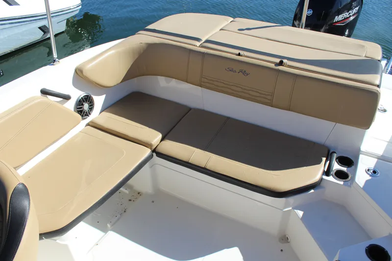 Slide: The Image of 2023 Sea Ray SPX 210 boat interior with tan seating and cup holders. - 19