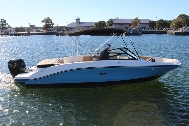 Slide: The Image of 2023 Sea Ray SPX 210 boat on water, featuring a sleek design and Mercury outboard engine. - 2