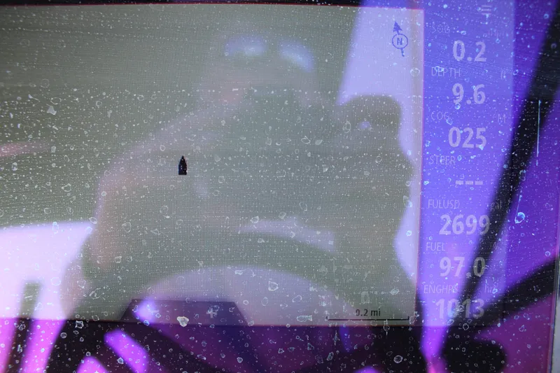 Slide: The Image of Dashboard display of a 2023 Sea Ray SPX 210 boat with raindrops. - 23