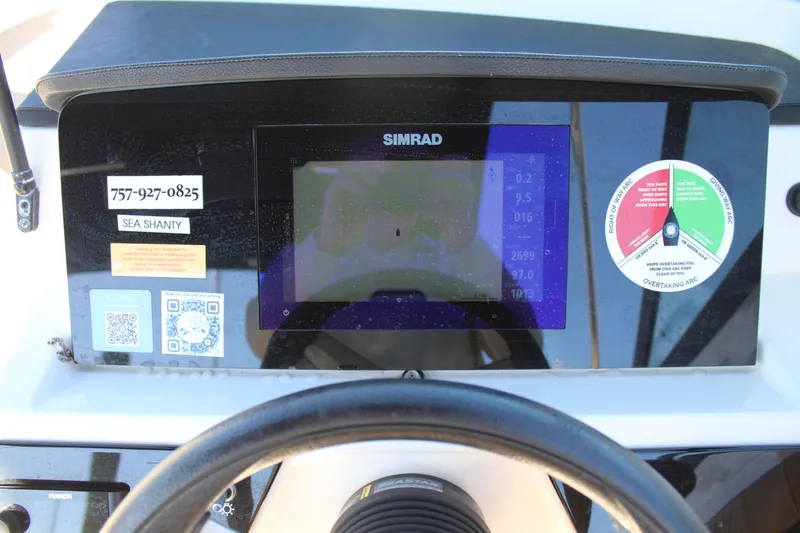 Slide: The Image of Dashboard of 2023 Sea Ray SPX 210 with Simrad display and navigation controls. - 24
