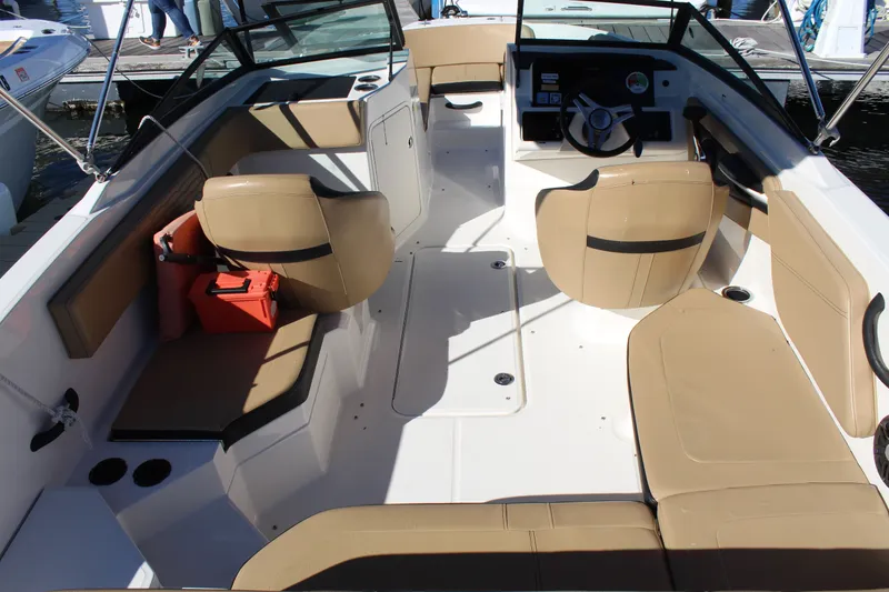 Slide: The Image of 2023 Sea Ray SPX 210 boat interior with tan seating and modern dashboard. - 29
