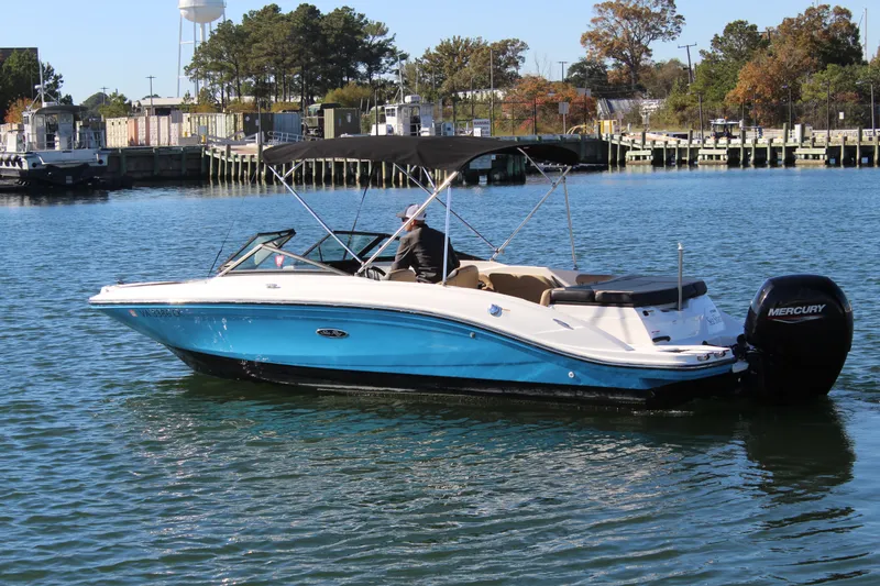 Slide: The Image of 2023 Sea Ray SPX 210 boat on water, featuring a blue hull and Mercury outboard motor. - 5