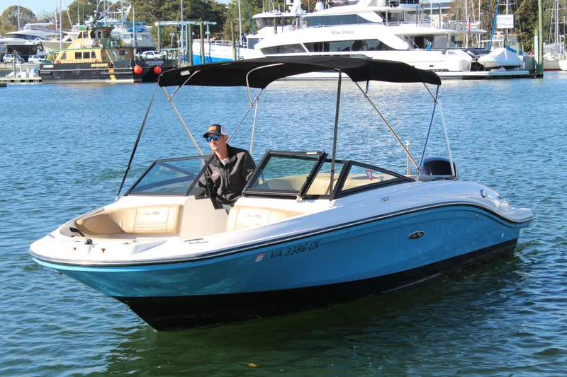 Slide: The Image of 2023 Sea Ray SPX 210 boat on water, featuring sleek design and canopy. - 7