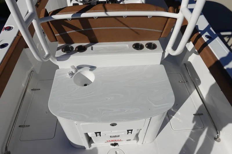 Slide: The Image of 2026 Sea Hunt Ultra 285 Coffin Box boat with T-top and rod holders against blue sky. - 15